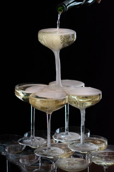 Pouring sparking wine into a DIY Champagne Tower