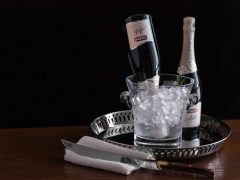 Sparkling wine chilling upside down in an ice bucket