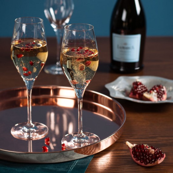 Sparkling wine glasses filled with Prosecco and fruit