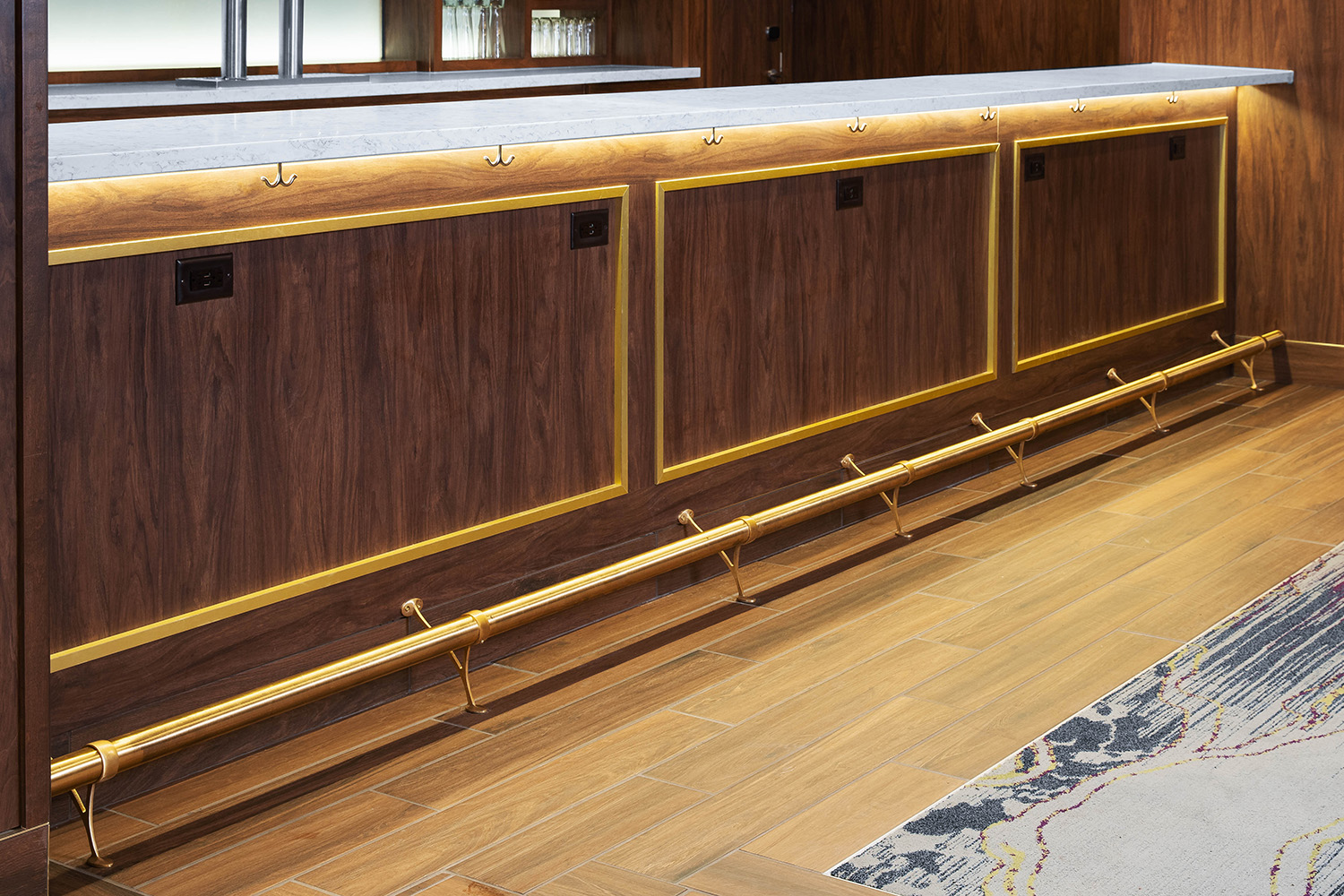 brushed brass bar rail installed